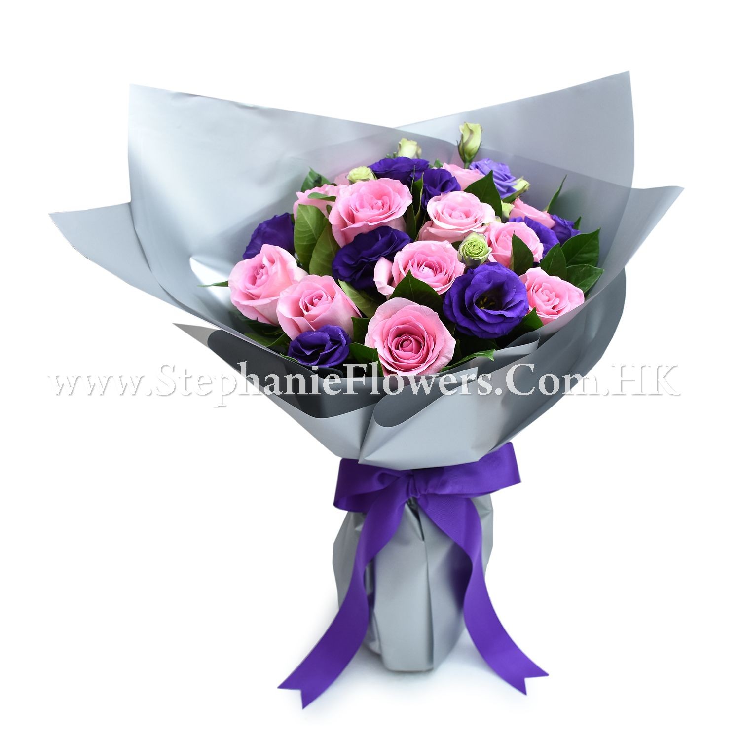 Bouquet of pink and purple roses wrapped in gray paper with a purple ribbon.