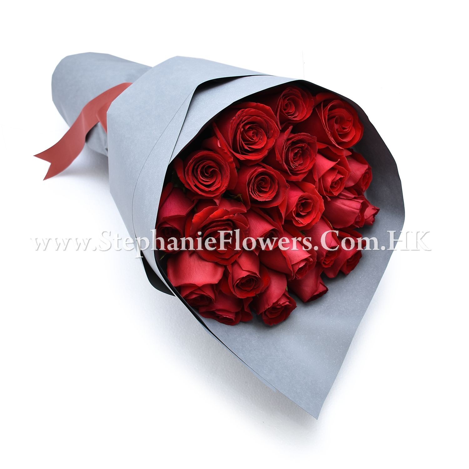 Bouquet of red roses wrapped in grey paper with a red ribbon.