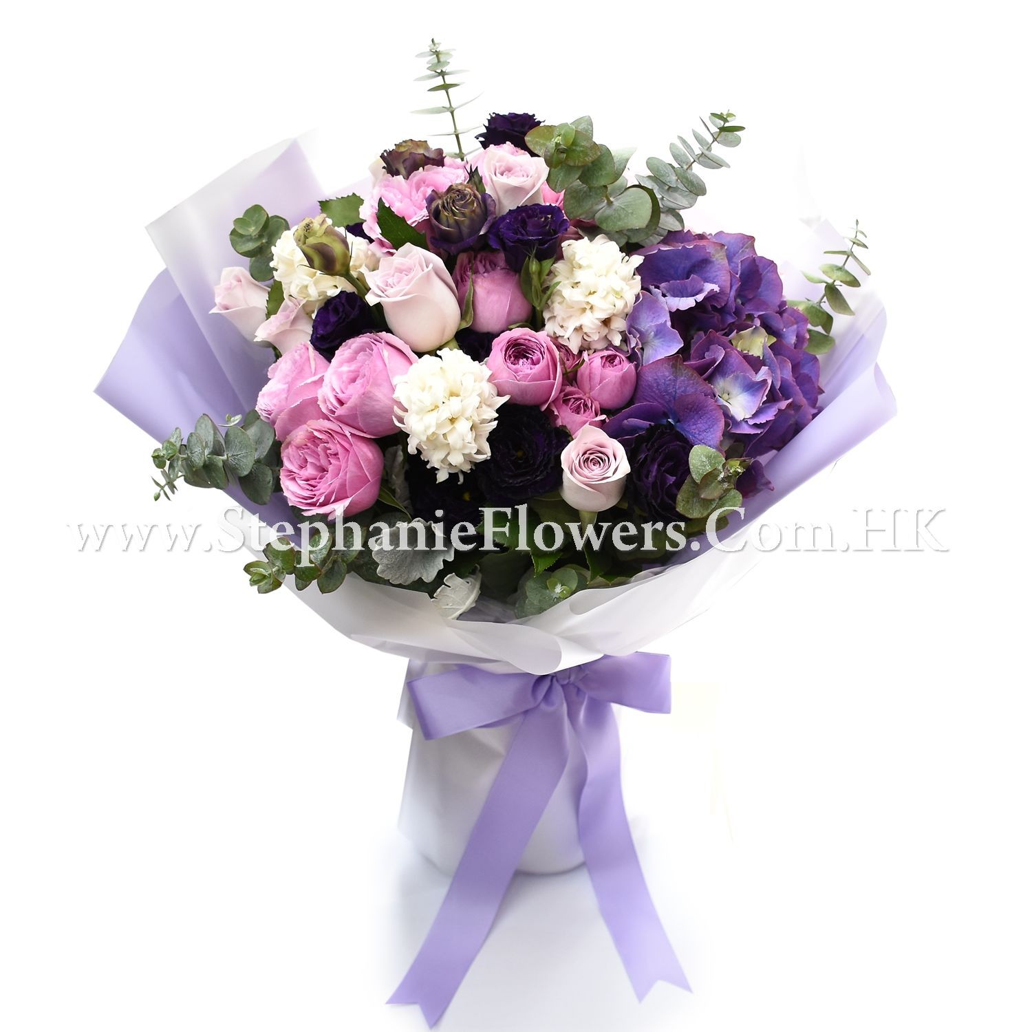 Elegant bouquet of pink and purple flowers with eucalyptus leaves, wrapped with white and purple ribbon.