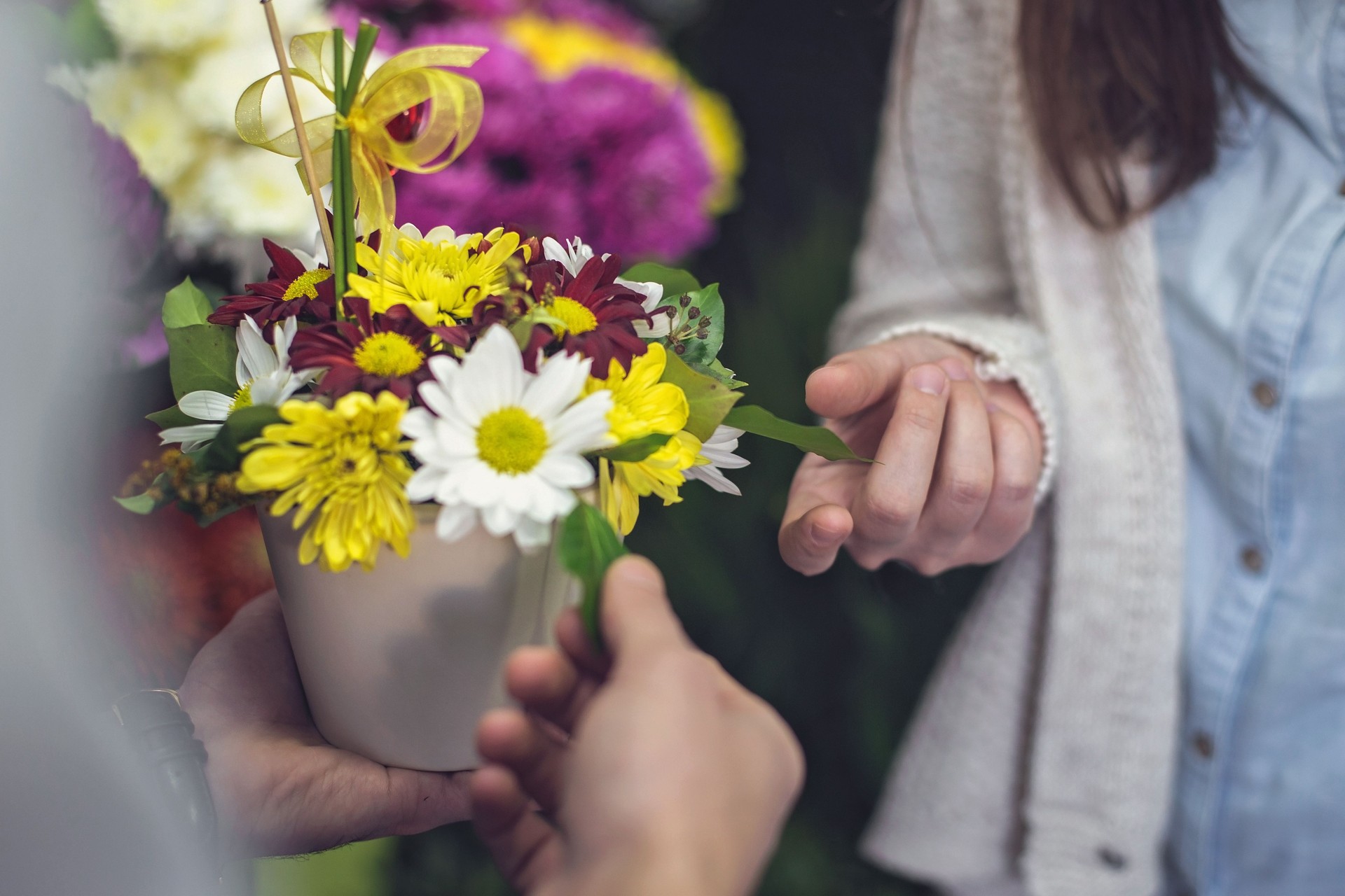 Man giving woman beautiful flower arrangement